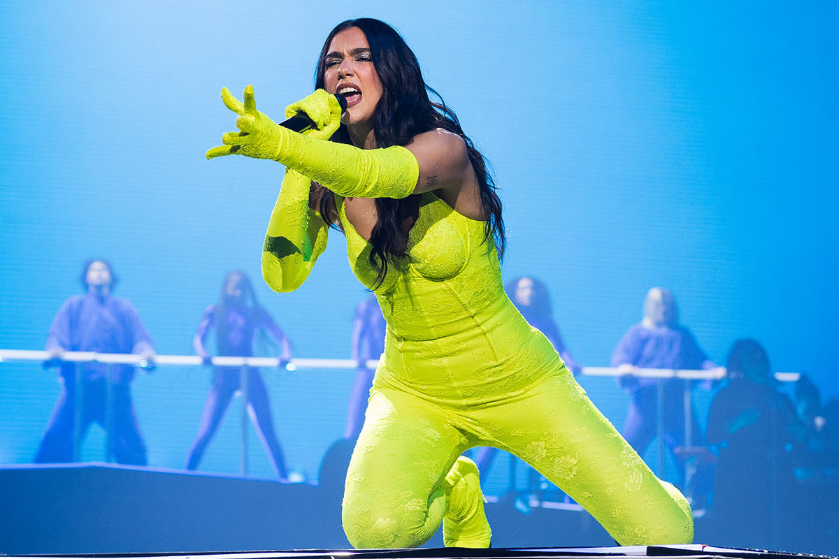 Dua Lipa performing on stage.
